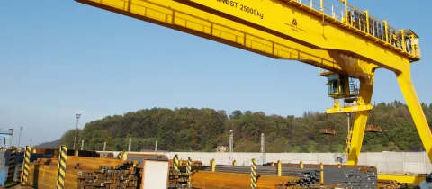 Process Crane with electromagnet at a loading facility in a steel mill