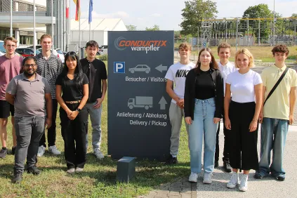 Young people standing in front of the Conductix-Wampfler CoE in Weil am Rhein, Germany