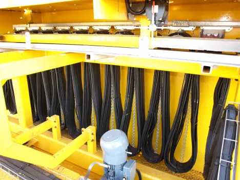 Process Crane with electromagnet at a loading facility in a steel mill