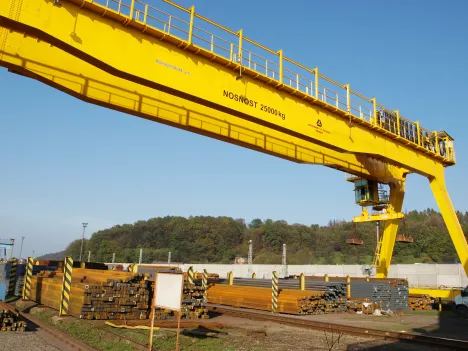 Process Crane with electromagnet at a loading facility in a steel mill