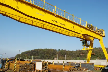 Process Crane with electromagnet at a loading facility in a steel mill